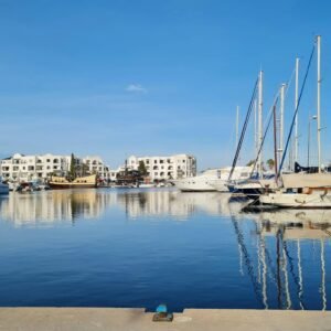 A serene view of yachts docked at the marina in Sousse, Tunisia, under a clear blue sky.