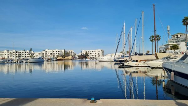 A serene view of yachts docked at the marina in Sousse, Tunisia, under a clear blue sky.