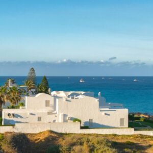 Beautiful coastal view of Kelibia with white buildings and a clear blue sea.