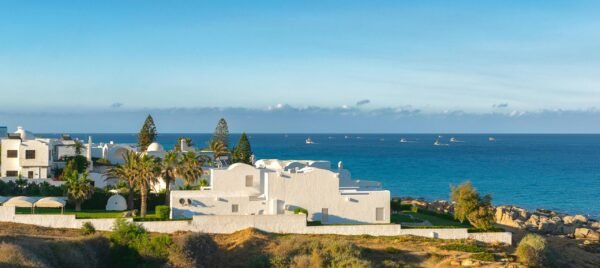 Beautiful coastal view of Kelibia with white buildings and a clear blue sea.