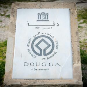 Stone marker designating Dougga as a UNESCO World Heritage Site.