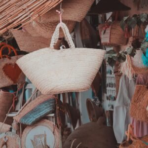 Explore a colorful display of handmade wicker baskets in Erriadh market, Tunisia.