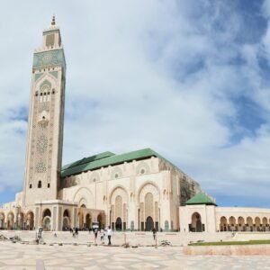 The iconic Hassan II Mosque in Casablanca under a blue sky, a key architectural masterpiece.