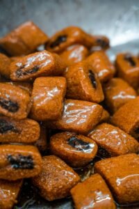 Close-up of glazed date-filled pastries, a traditional Tunisian sweet treat.
